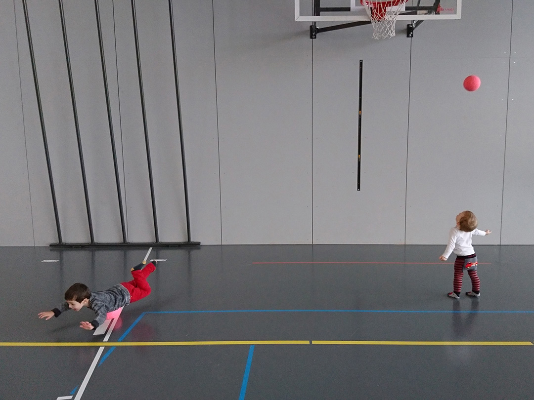 Kinder spielen mit Bällen in der Turnhalle beim Besuch mit der Kinderkrippe Stärnschnuppe